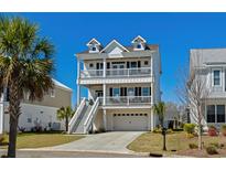 Charming three-story beach house with double balconies, white exterior, and well-maintained landscaping at 482 Harbour View Dr., Myrtle Beach, SC 29579