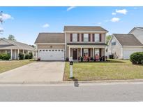 Charming two-story home with a well-maintained front yard and an attached two-car garage at 4916 Darby Ln., Myrtle Beach, SC 29579