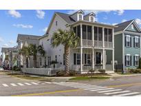 Charming two-story coastal home with a screened porch, white picket fence, and tropical landscaping at 780 Johnson Ave., Myrtle Beach, SC 29577