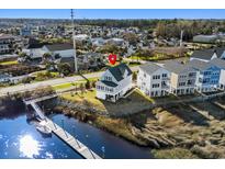 Beautiful coastal home with charming architecture, waterfront views, and private dock at 100 Marblehead Dr., Little River, SC 29566