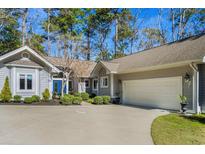 Charming single-story home with a large driveway and attached two-car garage surrounded by mature trees at 1240 Pine Valley Rd., North Myrtle Beach, SC 29582