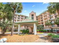 Beautiful condo complex featuring lush landscaping, manicured lawns, and a welcoming entrance at 145 S Dunes Dr. # 109, Pawleys Island, SC 29585
