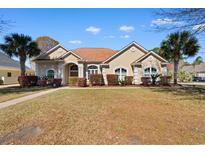 Charming single-story home with a well-maintained lawn, a brown roof and beautiful landscaping at 156 Henry Middleton Blvd., Myrtle Beach, SC 29588