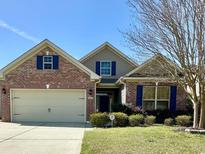 Charming brick home featuring blue shutters and a well-maintained lawn at 1612 Fairforest Ct., Conway, SC 29526
