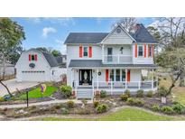 Inviting two-story home with a charming porch and well-maintained landscaping at 1631 27Th Ave. N, North Myrtle Beach, SC 29582