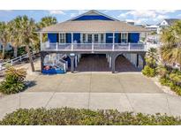 Charming blue coastal home with a spacious front porch and ground-level parking at 1644 South Waccamaw Dr., Murrells Inlet, SC 29576