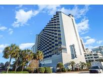 Stunning exterior view of a high-rise hotel featuring a unique staggered balcony design and lush tropical landscaping at 2001 S Ocean Blvd. # 1505, Myrtle Beach, SC 29577
