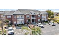 Apartment building with brick facade, white trim, balconies, and well-maintained landscaping at 2013 Silvercrest Dr. # 30-F, Myrtle Beach, SC 29579