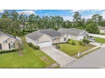 Charming single-story home with a well-manicured lawn, two-car garage, and mature landscaping at 221 Black Bear Rd., Myrtle Beach, SC 29588