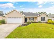 Charming single-story home with a well-manicured lawn, two-car garage, and welcoming front porch at 221 Black Bear Rd., Myrtle Beach, SC 29588