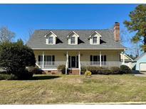 Charming home featuring dormer windows and a welcoming front porch, perfect for enjoying the outdoors at 2321 Brick Dr., Longs, SC 29568