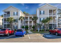 Beautiful condo buildings with well-maintained landscaping and convenient parking at 244 Sun Colony Blvd. # 102, Longs, SC 29568