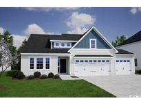 Charming two-story home featuring a three-car garage, manicured lawn, and inviting curb appeal at 265 Mayflower Dr., Calabash, NC 28467