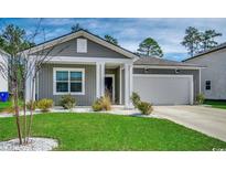 Charming single-story home featuring a well-manicured lawn and a classic gray exterior at 3039 Red Bark Dr., Conway, SC 29526