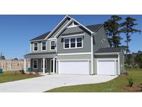 Charming two-story home with a two car garage and inviting curb appeal at 324 Mayflower Dr., Calabash, NC 28467