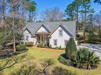 Charming single-Gathering home with manicured lawn, mature trees, and inviting curb appeal at 356 Savannah Dr., Pawleys Island, SC 29585