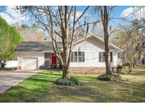 Charming single-story home with a red front door and a well-manicured lawn at 3740 Limerick Rd., Myrtle Beach, SC 29579