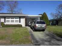 Charming single-story home featuring a long driveway and manicured front yard, perfect for suburban living at 3752 Tea Rose St. # 3752, Myrtle Beach, SC 29577