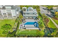 Stunning aerial view of a home with a pool, manicured backyard, outdoor kitchen, and palm trees at 3806 North Ocean Blvd., Myrtle Beach, SC 29577