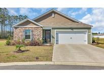 Charming single-story home featuring a brick facade, tidy landscaping, and a two-car garage at 416 Sage Cedar Place, Longs, SC 29568