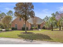 Charming red brick home with lush lawn, mature trees and well-maintained landscaping at 4222 Congressional Dr., Myrtle Beach, SC 29579