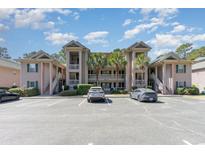 Inviting condo complex featuring covered balconies, lush landscaping and ample parking at 478 Pinehurst Ln. # 17D, Pawleys Island, SC 29585