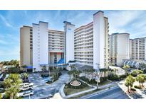 A beautiful view of the condos, lush greenery, and palm trees, a tranquil haven at 5300 N Ocean Blvd. # 708, Myrtle Beach, SC 29577