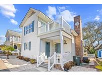 Charming two-story beach home with a second story balcony and nicely landscaped front yard at 600-B 43Rd Ave. S, North Myrtle Beach, SC 29582