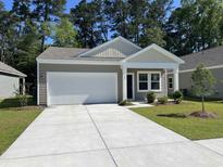 Charming single-story home with attached garage, well-manicured lawn, and mature trees at 639 Muster Field Ct., Conway, SC 29526