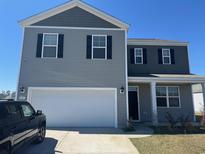 Charming two-story home featuring a two-car garage, classic shutters, and a well-maintained lawn at 645 Black Pearl Way, Myrtle Beach, SC 29588