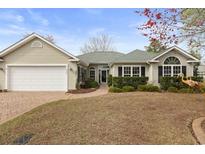 Charming single-story home with manicured landscaping, brick walkway, and attached two-car garage at 6904 Gina Ct., Myrtle Beach, SC 29588