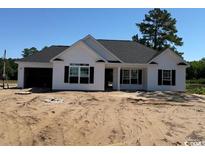 Charming single-story home featuring white siding, black shutters, and an attached two-car garage at 1278 Highway 45, Loris, SC 29569
