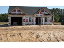 New construction home featuring a garage, windows, and gray roof at 1280 Highway 45, Loris, SC 29569
