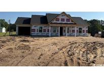 New construction showing a charming single story home with a spacious two car garage at 1284 Highway 45, Loris, SC 29569