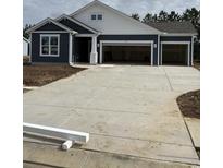 Charming exterior view of a modern home with a spacious three-car garage and concrete driveway at 191 Glengrove Lane, Murrells Inlet, SC 29576