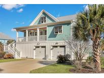 Charming two-story home features a two-car garage, a second floor patio, and beautiful landscaping at 392 Eagle Pass Dr., Murrells Inlet, SC 29576