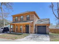 Stunning two-story home with a wood facade, inviting front porch, and attached garage at 4237 Brook Dr., Murrells Inlet, SC 29576