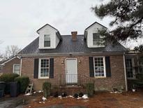 Charming brick home with dormers, black shutters, and a cozy front porch at 4300 Summitt Trail, Myrtle Beach, SC 29579