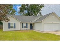 Charming single story home with manicured lawn, vinyl siding and a two car garage at 445 Saint Charles Circle, Myrtle Beach, SC 29588