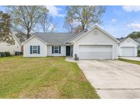 Well maintained single-Gathering home with lush lawn, driveway and two-car garage at 445 Saint Charles Circle, Myrtle Beach, SC 29588