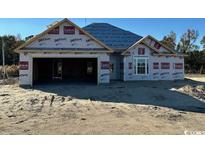 An unfinished single-Gathering home with a two-car garage on a sandy lot at 6242 Old Bucksville Rd., Conway, SC 29527