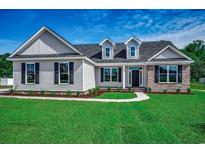 Charming single-Gathering home featuring a well-manicured lawn and traditional architectural design at 646 Sunny Pond Ln., Aynor, SC 29511