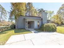 Charming single story home featuring a gray exterior, mature landscaping, and a spacious front yard at 103 Ebb Tide Harbour, Myrtle Beach, SC 29577