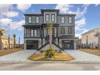 Stunning three-story home featuring a stylish facade, dual garages, and an inviting landscaped entrance at 105 Serenity Point Dr., Little River, SC 29566