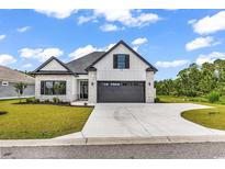 Charming new construction home featuring stone accents and a spacious driveway at 144 Sago Palm Dr., Myrtle Beach, SC 29579