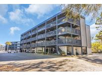 This four-story building has wood and steel accents, multiple balconies, and convenient covered parking at 1500 Cenith Dr. # E302, North Myrtle Beach, SC 29582