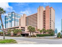 Stunning resort building with lush landscaping, offering convenient parking and luxurious amenities at 2207 S Ocean Blvd. # 1515, Myrtle Beach, SC 29577