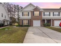 Charming two-story townhome featuring a brick facade, attached garage, and well-maintained landscaping at 223 Connemara Dr. # A, Myrtle Beach, SC 29579