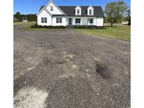 Charming two-story home with black shutters, landscaping and a circular driveway at 3534 Carter Rd., Loris, SC 29569
