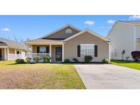 Charming single-story home featuring a cozy front porch and well-maintained landscaping at 4738 Southgate Pkwy., Myrtle Beach, SC 29579
